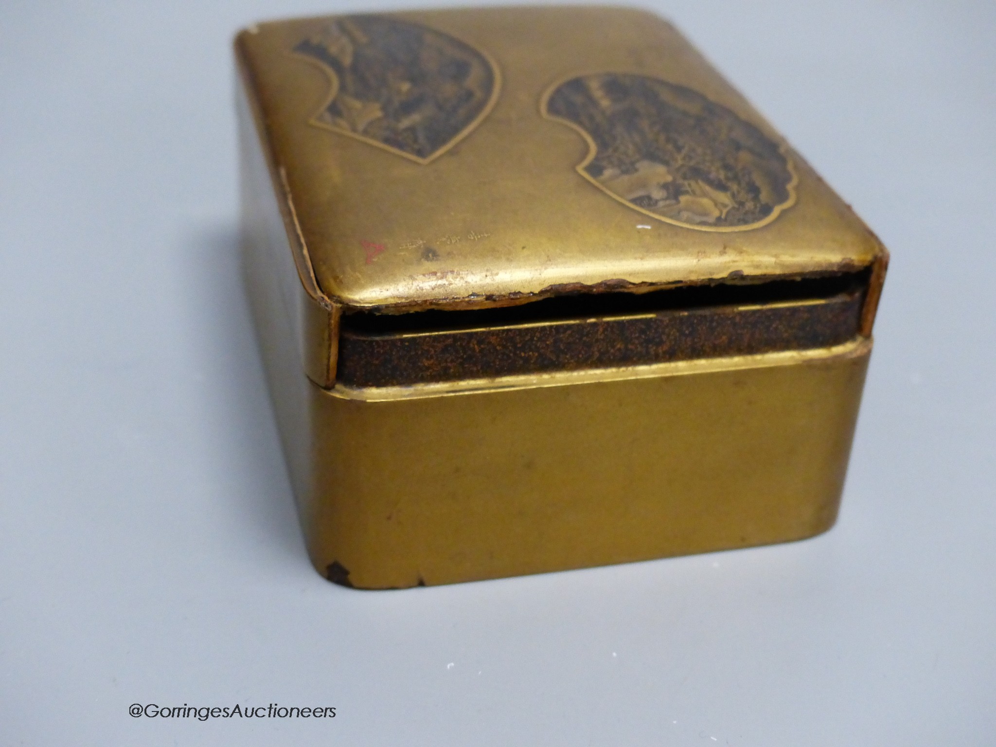 A Japanese lacquer jar and cover, a box and cover, a photo frame,22 x 18cm and an antimony figure of Gama Senin